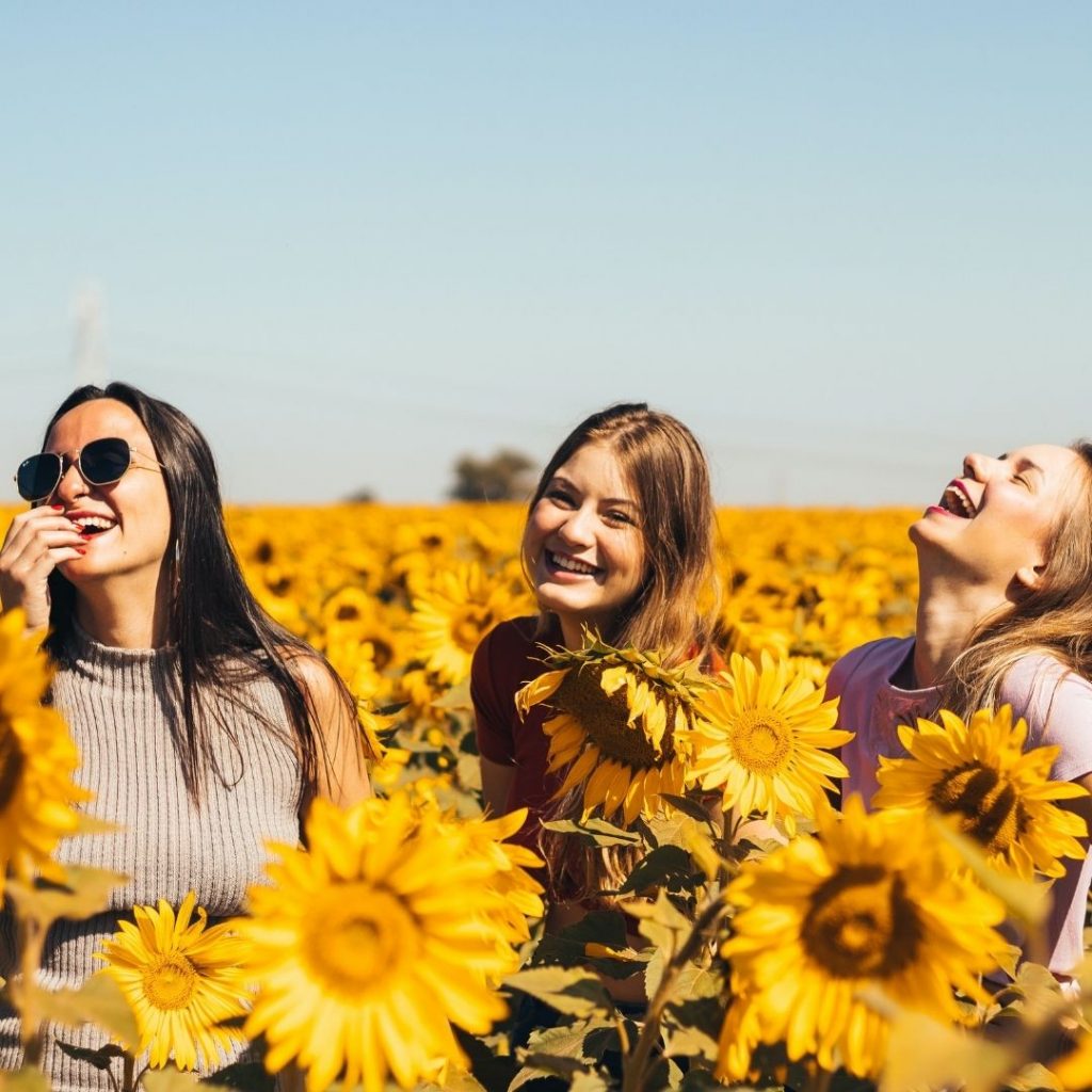 women in field of sunflowers